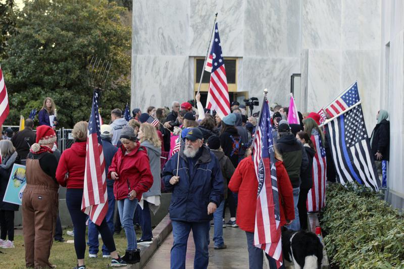 A group of people standing in front of a crowd